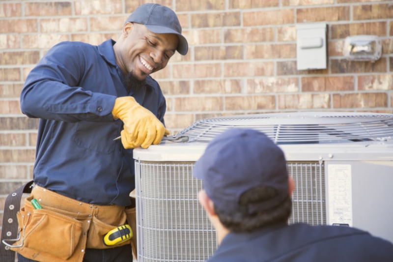 Air Conditioning Short Cycling Help - Technicians work on outdoor AC Unit.