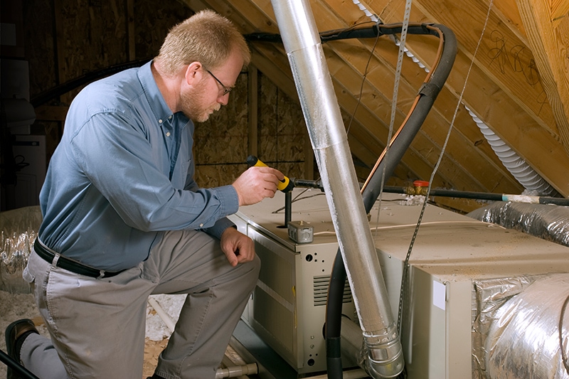 How Do I Know When I Need a New Furnace? - Man Replacing Furnace.